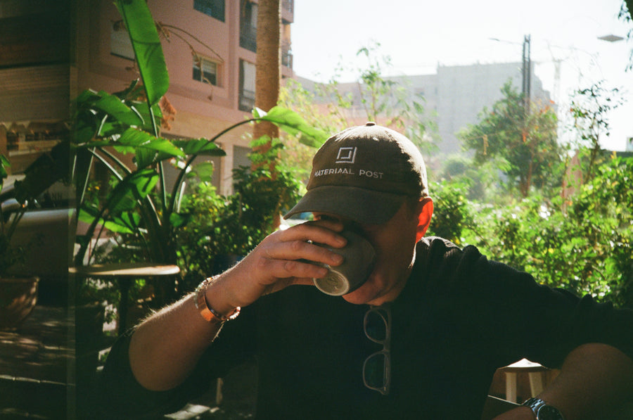 Coffee outdoors in a Materiaal Post cap.