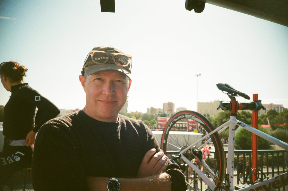 A Materiaal Post cap, a bike on a repair stand, and time in the race pits.